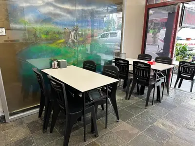 a dining room with tables and chairs in a restaurant at Hotel BB Inn @ Cameron in Cameron Highlands