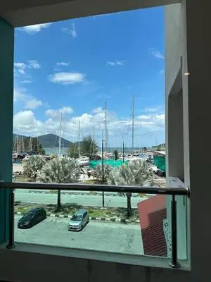 a window with a view of a parking lot at Laguna Raudhah Apartment in Lumut