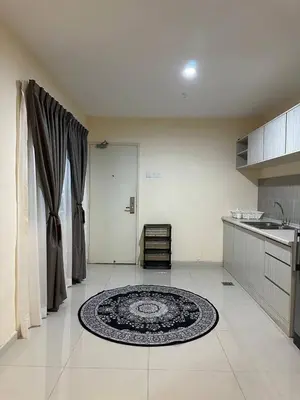a kitchen with a large rug on the floor at Laguna Raudhah Apartment in Lumut