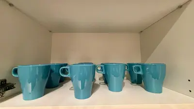 a row of blue cups sitting on a shelf at Spacious HOUSE 4R 8pax WiFi-S Pic-Airport in Bayan Lepas