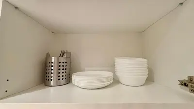 a shelf with plates and utensils in a kitchen at Spacious HOUSE 4R 8pax WiFi-S Pic-Airport in Bayan Lepas