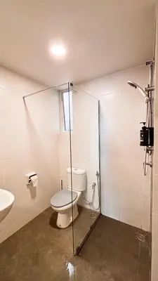 a bathroom with a toilet and a glass shower stall at Spacious HOUSE 4R 8pax WiFi-S Pic-Airport in Bayan Lepas