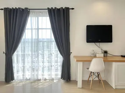 a room with a desk and a window with curtains at Cozy Suite - Near UTAR - Champs Elysees Kampar in Kampar