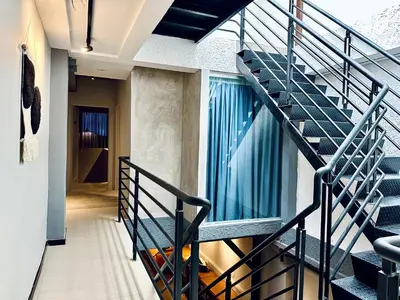 a staircase leading to the second floor of a house at Georgetown landed Guest House WL in George Town