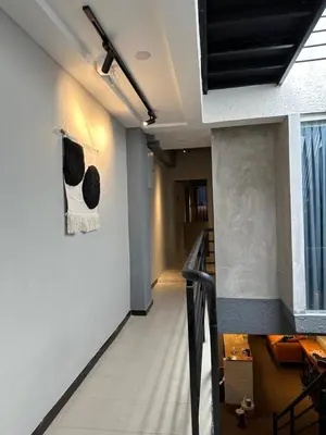 a hallway with a stairway with a stair case at Georgetown landed Guest House WL in George Town