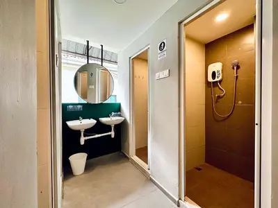a bathroom with two sinks and a mirror at Georgetown landed Guest House WL in George Town