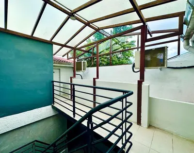 a balcony with a metal railing on a building at Georgetown landed Guest House WL in George Town