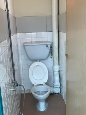 a small bathroom with a toilet in a stall at GOPENG INN Homestay in Gopeng