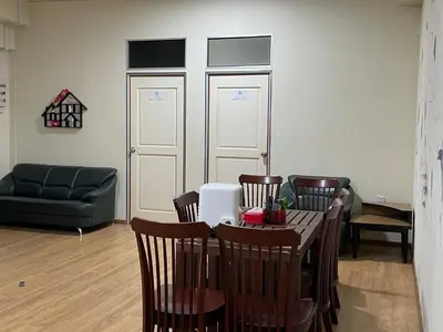 a living room with a table and chairs and a couch at GOPENG INN Homestay in Gopeng