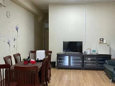a living room with a table and a flat screen tv at GOPENG INN Homestay in Gopeng