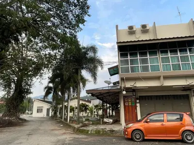 a small orange car parked in front of a building at GOPENG INN Homestay in Gopeng