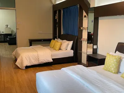 a hotel room with two beds with yellow pillows at GOPENG INN Homestay in Gopeng
