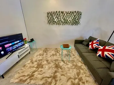 a living room with a couch and a flat screen tv at Home41#4pax#Netflix#NearAeonAlma#BM#5kmtoIconicPoint in Bukit Mertajam