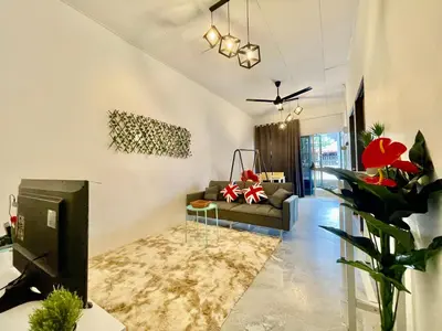 a living room with a couch and a tv at Home41#4pax#Netflix#NearAeonAlma#BM#5kmtoIconicPoint in Bukit Mertajam