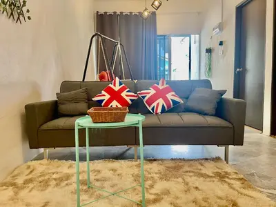 a living room with a couch and a table with pillows at Home41#4pax#Netflix#NearAeonAlma#BM#5kmtoIconicPoint in Bukit Mertajam