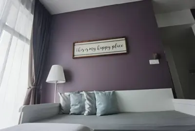 a bedroom with a purple wall with a bed and a picture at G Residence - 2BR Family Suite Barrington Night Market - 4 in Brinchang