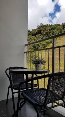 a table and two chairs on a balcony with a table at G Residence - 2BR Family Suite Barrington Night Market - 4 in Brinchang