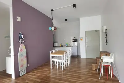 a kitchen and dining room with a table and a skateboard at G Residence - 2BR Family Suite Barrington Night Market - 4 in Brinchang