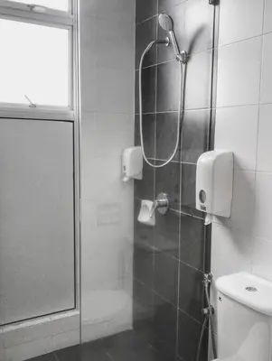 a bathroom with a shower with a glass door at G Residence - 2BR Family Suite Barrington Night Market - 4 in Brinchang