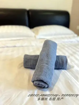 a rolled up towel on top of a bed at 10pax -2 Storey House Bayu Mutiara at Bukit Mertajam in Bukit Mertajam