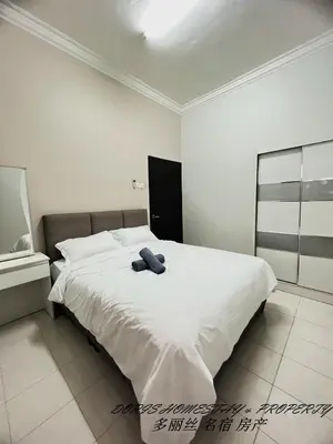 a large white bed with a blue object on it at 10pax -2 Storey House Bayu Mutiara at Bukit Mertajam in Bukit Mertajam