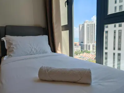 a bed in a room with a large window at Harmony Haven with Bathtub - Jazz Suites by Ocean Luxe in Tanjong Tokong
