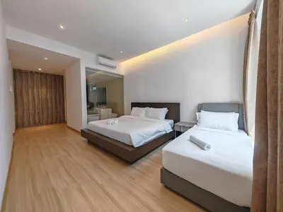 a hotel room with two beds and a bathroom at Harmony Haven with Bathtub - Jazz Suites by Ocean Luxe in Tanjong Tokong