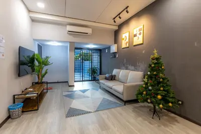 a christmas tree in a living room with a couch at 5R4B 15Pax V KTV,KID'S POOL,POOL TABLE NEAR USM,LWE HOSPITAL,SPI ARENA in George Town