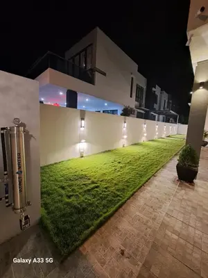 a building with a green lawn in front of it at Varnen Cozy Haven - EVCharger in Bukit Mertajam
