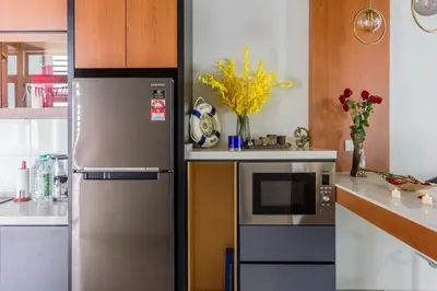 a kitchen with a refrigerator and a microwave at Varnen Cozy Haven - EVCharger in Bukit Mertajam