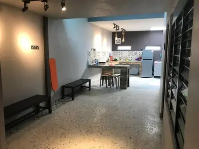a kitchen and dining room with a table and chairs at Wi-Fi 100MB Free Ipoh Holiday Suite Taman Anda A5 in Ipoh