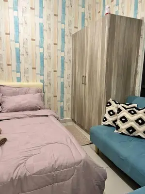 a bedroom with a bed and a blue couch at Lily Fair ~ Cameron Highlands in Tanah Rata