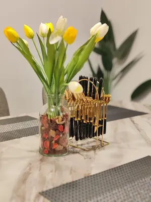 a vase filled with flowers sitting on top of a table at D'Elegant Suite - Emerald Avenue in Cameron Highlands