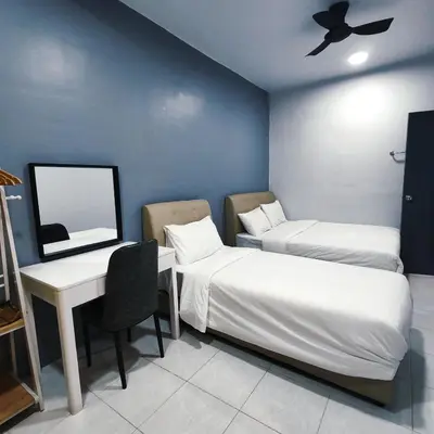a room with two beds and a desk and a mirror at D'Elegant Suite - Emerald Avenue in Cameron Highlands