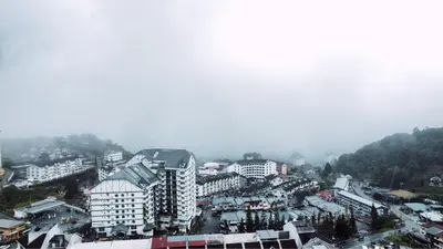 a city in the fog with buildings and trees at D'Elegant Suite - Emerald Avenue in Cameron Highlands
