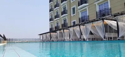 a large swimming pool in front of a building at Champs Elysees by Landmark @ Kampar in Kampong Malim Nawar