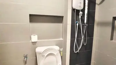 a bathroom with a shower and a toilet in it at Champs Elysees by Landmark @ Kampar in Kampong Malim Nawar