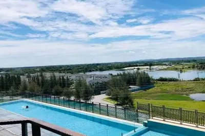 a swimming pool on top of a building with a view of a lake at Champs Elysees by Landmark @ Kampar in Kampong Malim Nawar