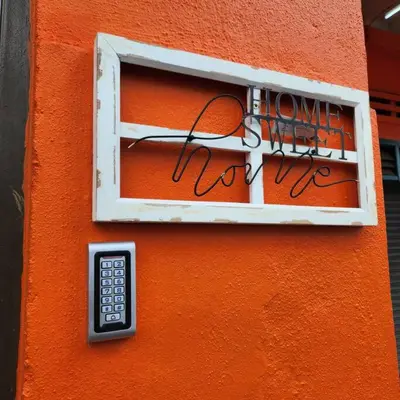 a window with a remote control on a orange wall at Ipoh town centre - safari 5 pax(2BR) in Ipoh