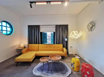 a living room with a yellow couch and a table at Ipoh town centre eastern oriental 8 pax(2BR) in Ipoh