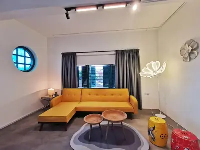 a living room with a yellow couch and a window at Ipoh town centre eastern oriental 8 pax(2BR) in Ipoh
