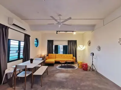 a living room with a yellow couch and a table at Ipoh town centre eastern oriental 8 pax(2BR) in Ipoh