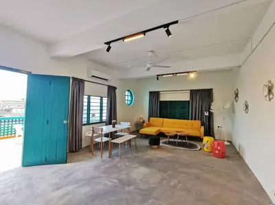 a living room with a yellow couch and a table at Ipoh town centre eastern oriental 8 pax(2BR) in Ipoh