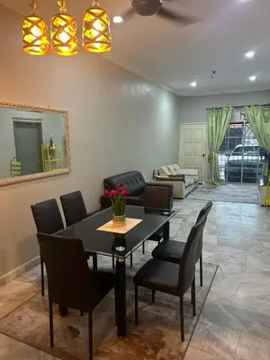 a living room with a dining room table and chairs at Hz Homestay Bertam in Kepala Batas