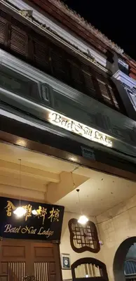 a building with a sign on the side of it at Betel Nut Lodge in George Town