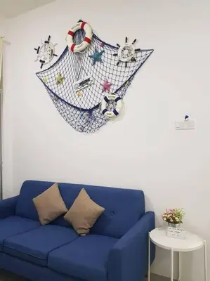 a blue couch in a living room with a net on the wall at BLUE DOME (Santorini) @ Night Market, Cameron Highlands in Brinchang
