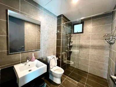 a bathroom with a sink and a toilet and a mirror at Ipoh Onsen family suite l Lost World view in Tambun