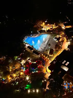 an overhead view of a pool at night at Ipoh Onsen family suite l Lost World view in Tambun