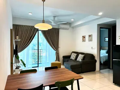 a living room with a table and a couch at Ipoh Onsen family suite l Lost World view in Tambun