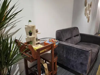 a living room with a couch and a table at Le Melur in George Town